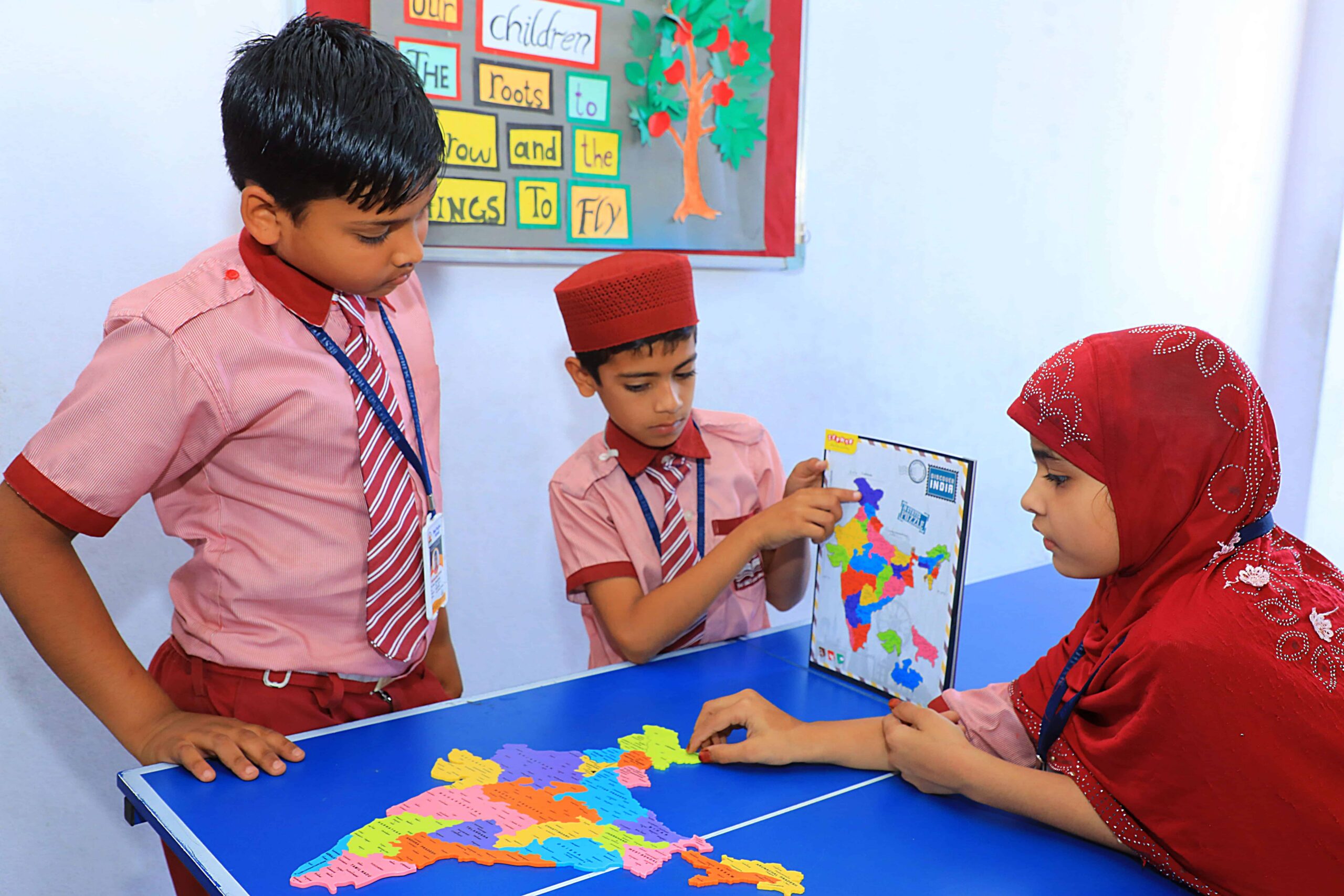 Students at Best Techno School participating in a practical geography activity using an India map puzzle and educational materials to enhance interactive learning and teamwork.