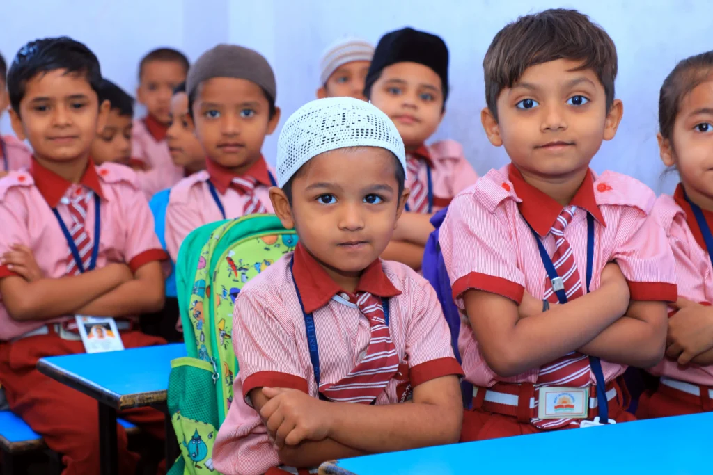 A group of young students seated in a classroom at Best Techno School, attentively participating in lessons in a positive and inclusive learning environment.