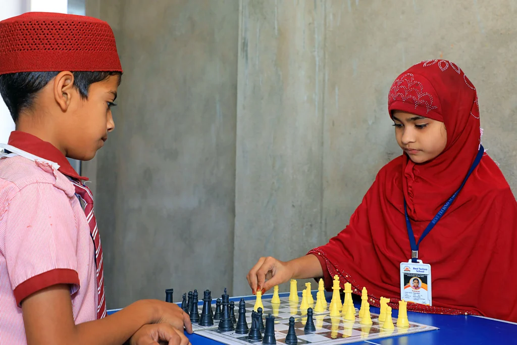 Two Best Techno School students playing chess during a co-curricular activity, enhancing critical thinking, concentration, and problem-solving skills.